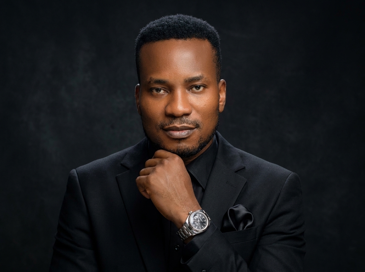 Amb. John Ifeanyi Amos in black formal suit suited for executive keynotes and diplomatic addresses